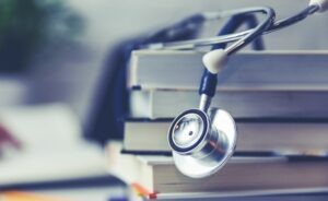 A stethoscope with textbooks for medical training