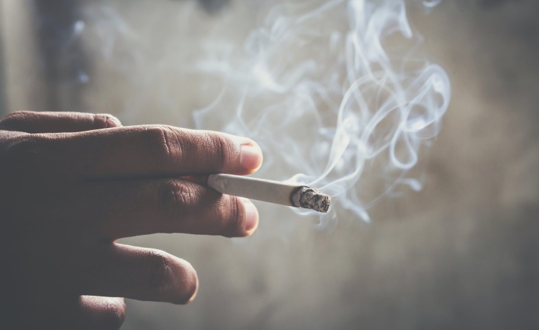 Smoker holding a lit cigarette