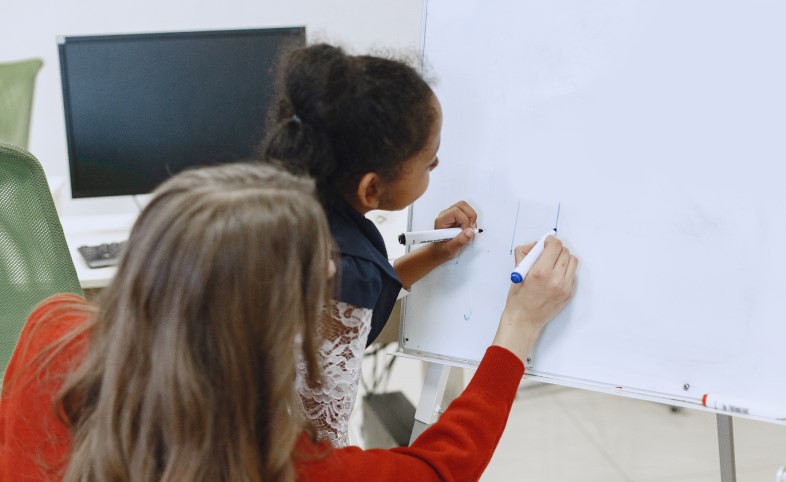 Girl in science class with female teacher