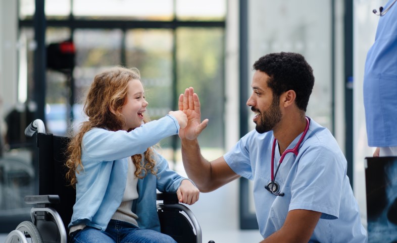 doctor with child in wheelchair