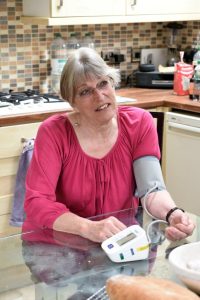 Woman taking her own blood pressure