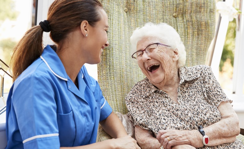 Older lady with nurse healthcare assistant