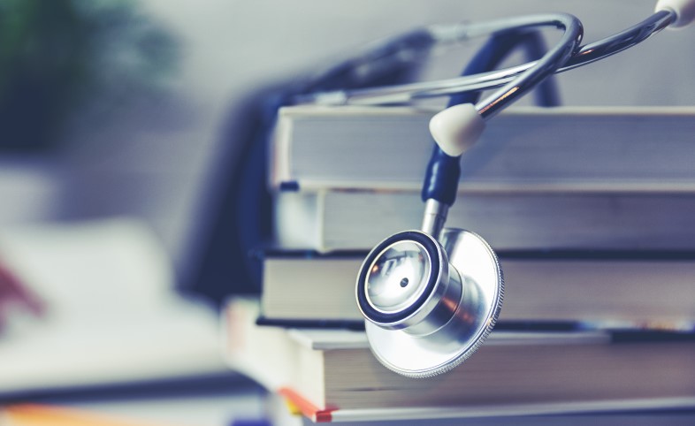 A stethoscope with textbooks for medical training